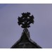 Fleur-de-lis on tip, flowery solar disc on steeple